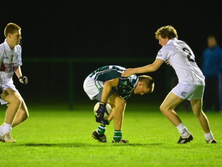 11-10-2013Confey's Sean Kilbane keeps the ball from Sean Lynch and Andy Malone of Clane in the Minor B football final replay at Hawkfield.Photo: Adrian Melia