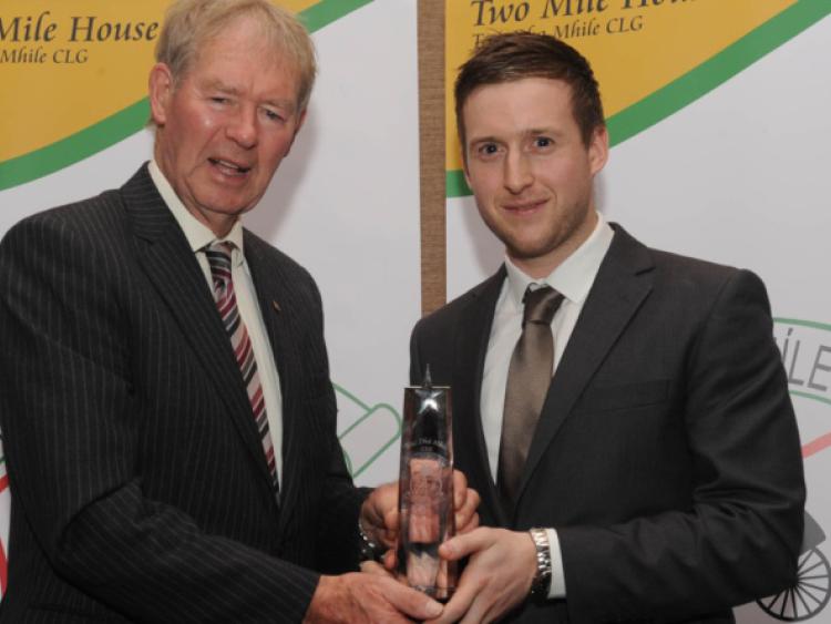 Senior Player of the Year Brian Byrne accepts his award from Michael O Muircheartaigh at the Two Mile House dinner dance at Kilashee House Hotel.