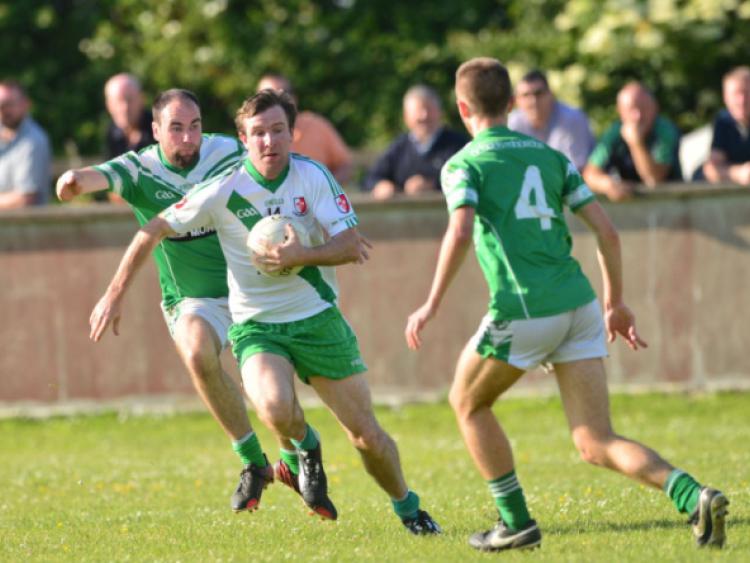 Robbie Confrey of Sarsfields tries to get away from Ger Naughton of Moorefield in the SFL game at Moorefield.