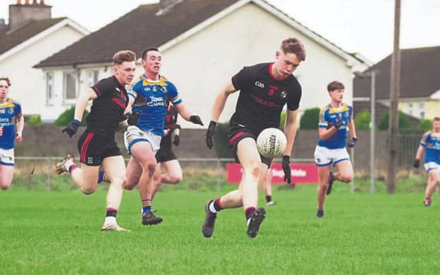 Ardscoil Captain Eoin Johnson gets away from Naas Cian McKevitt