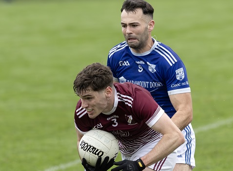 Caragh full back Matthew McNally drives up field to set up an attack despite the chasing Ryan Owens of Meath Hill during the AIB Leinster Club Championship game