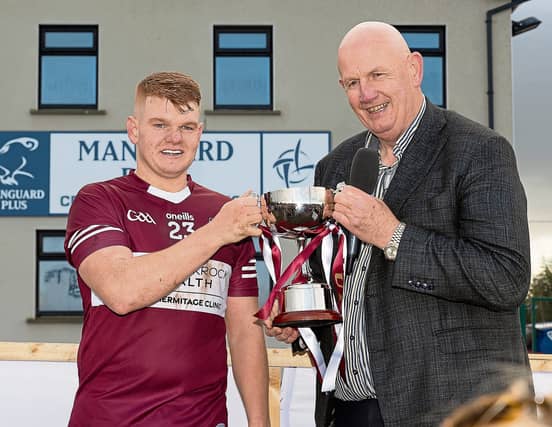 Leixlip Captain Conor Burke accepts the Senior B Cup from Kildare GAA County Chairperson Mick Gorman