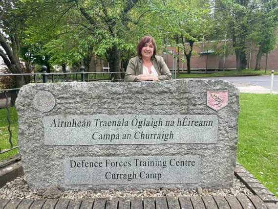 Senator Fiona O'Loughlin leaning against the sign for the Defence Forces Training Centre in the Curragh Camp. Pic supplied.
