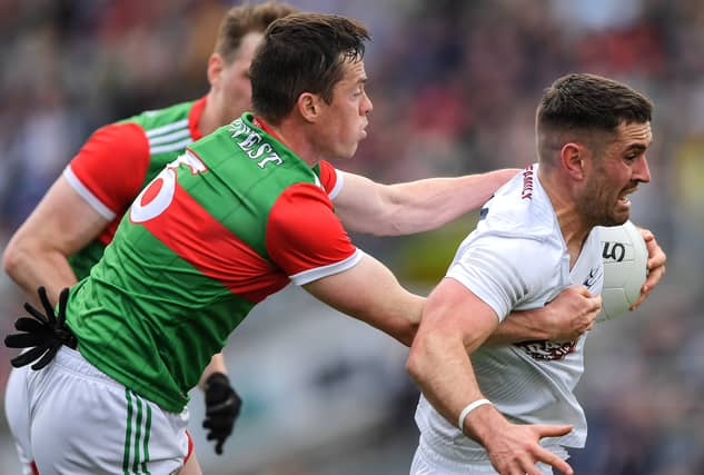 Ben McCormack of Kildare is tackled by Stephen Coen of Mayo during the GAA Football All-Ireland Senior Championship Round 2 match between Mayo and Kildare at Croke Park in Dublin. Photo by Ray McManus