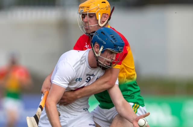 Kildare Kevin Kelleher gets his hand pass away despite the tight hold of Carlow Scott Tracey during the Leinster Gaa U20 Hurling Championship
