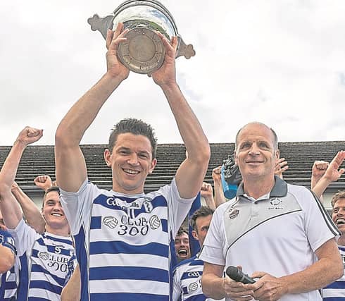 Naas captain Eamonn Callaghan lifts the Leinster Leader Cup in 2019