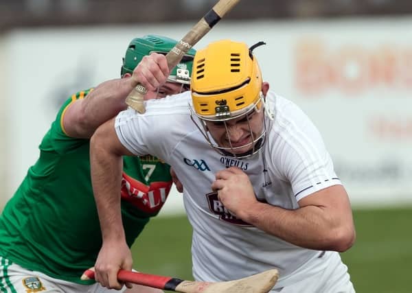 Conor Dowling (Kildare) comes out with the ball ahead of Meath's Cris Lynch in the Kehoe Cup