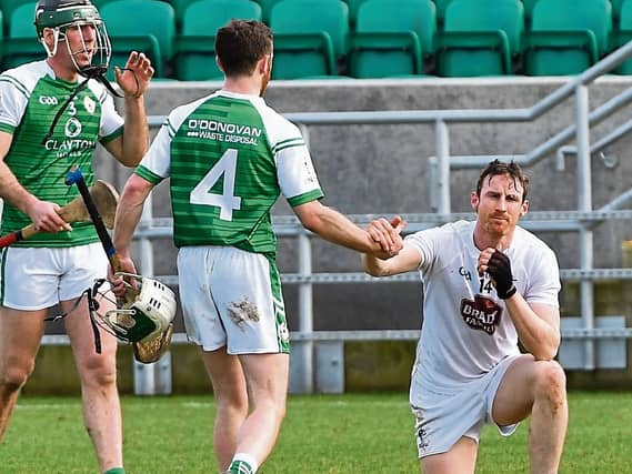 Conor Hickey, London, comisserates with Kildare's Eanna O'Neill
