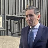 Head and shoulders photo of Simon Harris speaking outside