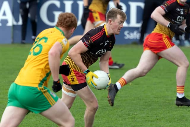 St Laurences midfielder Mark Glynn being pursued by Michael McLoughlin of Two Mile House in the 2025 National Electrical Wholesalers Intermediate Football Championship