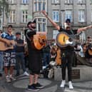 Musicians play in memory of Glen Hansard on King Street in Dublin