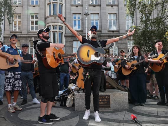 Musicians play in memory of Glen Hansard on King Street in Dublin