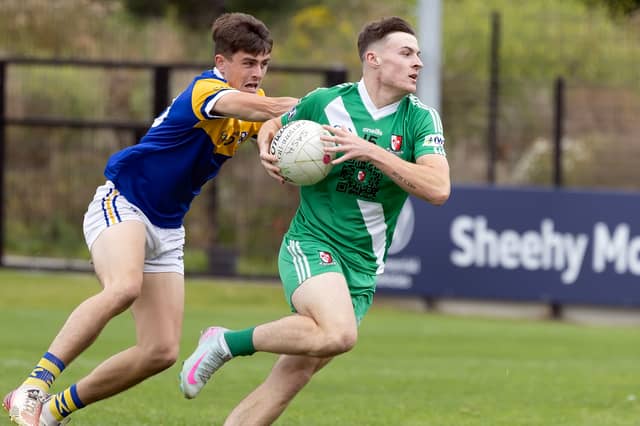 Sarsfields forward Ben Loakman tries to get away from Evan Boyle of Carbury in the Kildare SFC