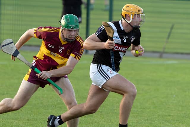 Maynooth midfielder Oran Byrne breaks free from the tackling Paul Dolan of Éire Óg Corra Choill in Round 1 of the Kildare SHC