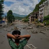 A boy looks at the devastation caused by flash flooding along the Trishuli River in Nepal’s Nuwakot district