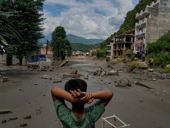 A boy looks at the devastation caused by flash flooding along the Trishuli River in Nepal’s Nuwakot district