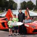 Irish Formula 2 racing driver Alex Dunne pictured with Phoebe Quail (7) and Jimmie Quail (10) at the announcement that Ronald McDonald House will be the official charity partner for Ireland's biggest supercar event Cannonball 2026