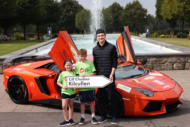 Irish Formula 2 racing driver Alex Dunne pictured with Phoebe Quail (7) and Jimmie Quail (10) at the announcement that Ronald McDonald House will be the official charity partner for Ireland's biggest supercar event Cannonball 2026