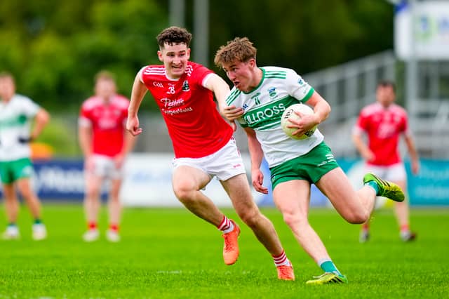 Colm Dalton in action is tackled by Padraig Spillane