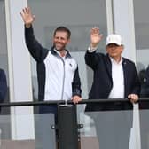 US President Donald Trump with his son Eric Trump waving to spectators