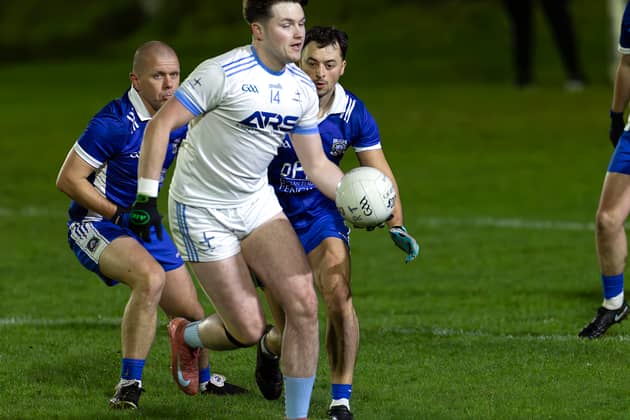 Athgarvan full forward Jordan Nolan Mullaly turns away from Robertstown duo of Danny Scully and Athony Moran