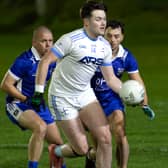 Athgarvan full forward Jordan Nolan Mullaly turns away from Robertstown duo of Danny Scully and Athony Moran