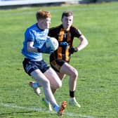 Eadestown center forward Conor Morrin puts on the breaks as he goes around Round Towers Noah Quinn. Photo: Sean Brilly