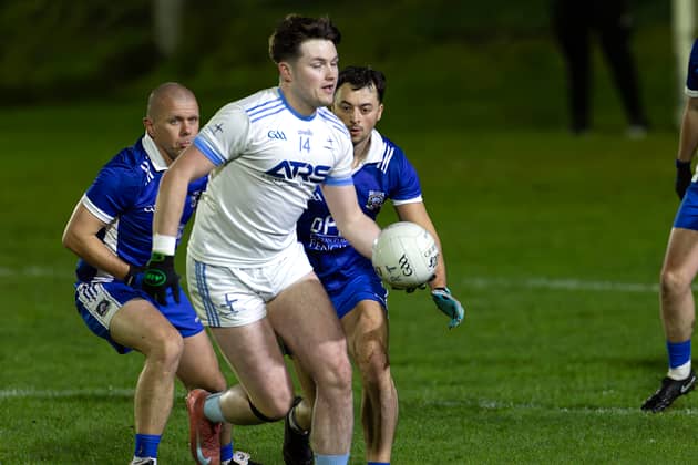 Athgarvan full-forward Jordan Nolan Mullally turns away from Robertstown duo Danny Scully and Anthony Moran