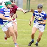Naas midfielder Mac Dara Moore goes clear from the challenge of Leixlip wing-back James Canning with Liam Walshe in support in IHC action