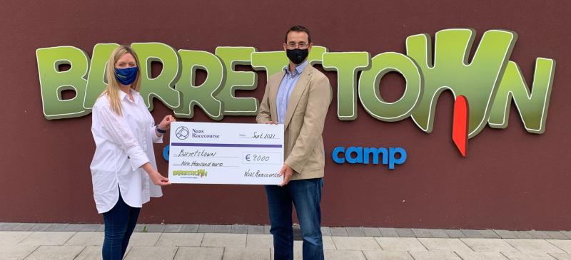  Eamonn McEvoy, General Manager of Naas Racecourse pictured with Caroline Tobin,  Corporate Account Manager of Barretstown with a €9,000 cheque for Barretstown Children