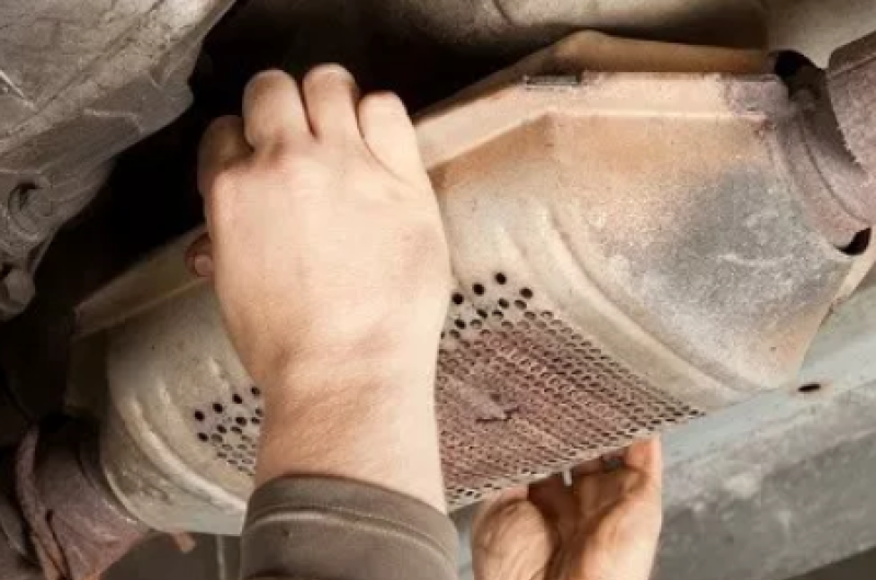 catalytic converter being removed from car