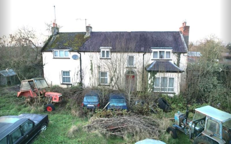 FOR SALE: Dumped cars and tractors in front garden  of 4-bed house on market 