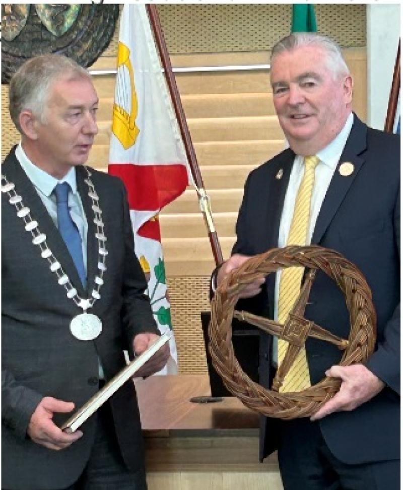 Mayor of Freehold, Kevin Kane is presented a St Brigid's Cross by former Kildare Newbridge MD Cathaoirleach Paddy Curran