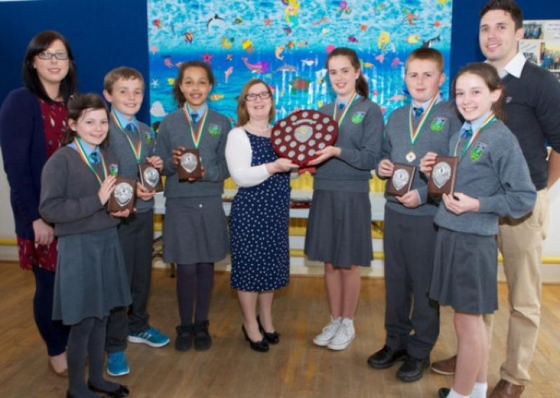 Teachers, Margaret McMahon (left), and Chris Grehan (right), with pupils of the Two-mile-house National School All Ireland winning Debating Team, (l-r) Erica Byrne, Adam Conneely, Hannah Conroy; dolores Hamill, Director of Kildare Education Centre presenting the Trophy; Niamh Coyle, Luke Coy and Megan McLoughlin. Photo Tony Keane.
