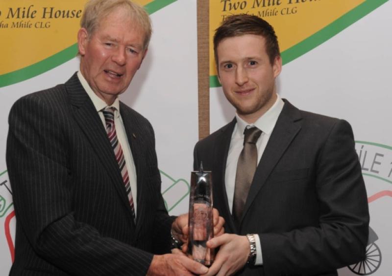 Senior Player of the Year Brian Byrne accepts his award from Michael O Muircheartaigh at the Two Mile House dinner dance at Kilashee House Hotel.