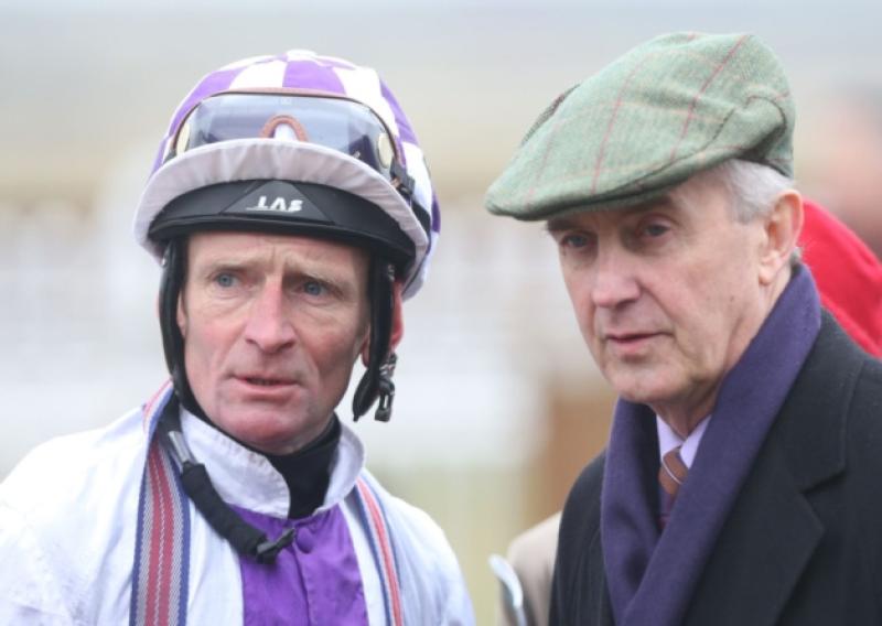 Jockey Kevin Manning and Trainer Jim Bolger looking to the charity hurling game in Newbrige on Tuesday evening.