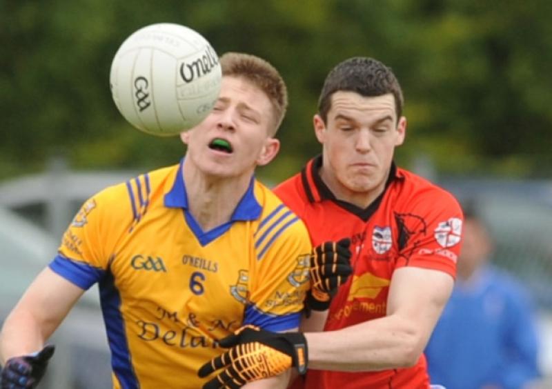 Shane Bergin of Naas gets the ball from Dylan Corcoran of Celbridge in the Senior Football Championship round 1 game at Clane.