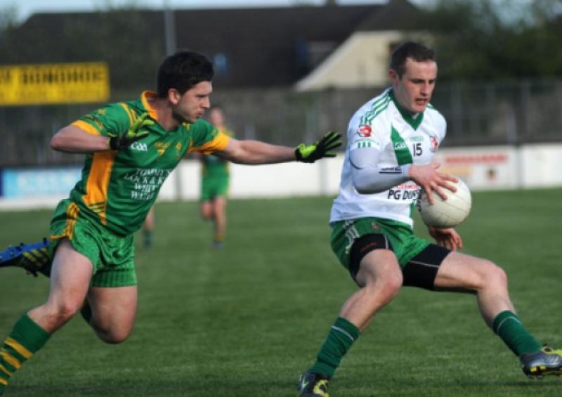 Alan Smith kicks a point for Sarsfields past Keith Conway of Ballymore in the MDY Construction senior football championship game at St Conleth's Park, Newbridge. Picture: Adrian Melia