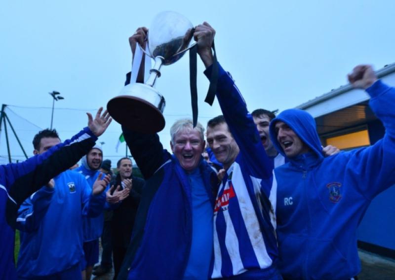 Castle Villa captain Anto Lawlor celebrates with the cup and Liam Murphy after victory over Naas United in the Kildare and  District Football League CR Wynne Feeds Senior Division decider at Mullarkey Park.