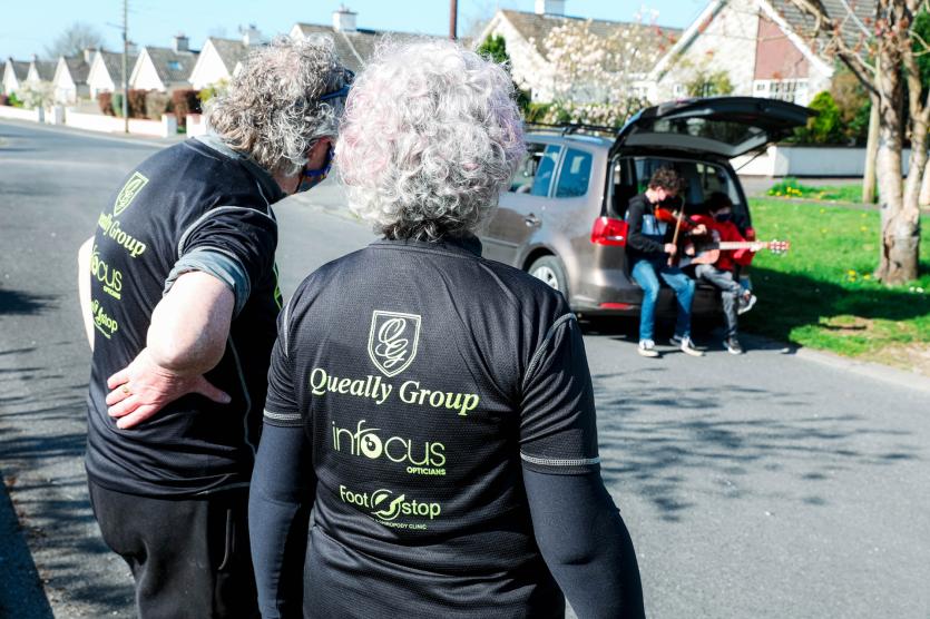 Mary and Vinnie Walsh are entertained by Tom and Joe Gallagher in Kingsfurze Ave before their 5k walk in memory of daughter Sheena